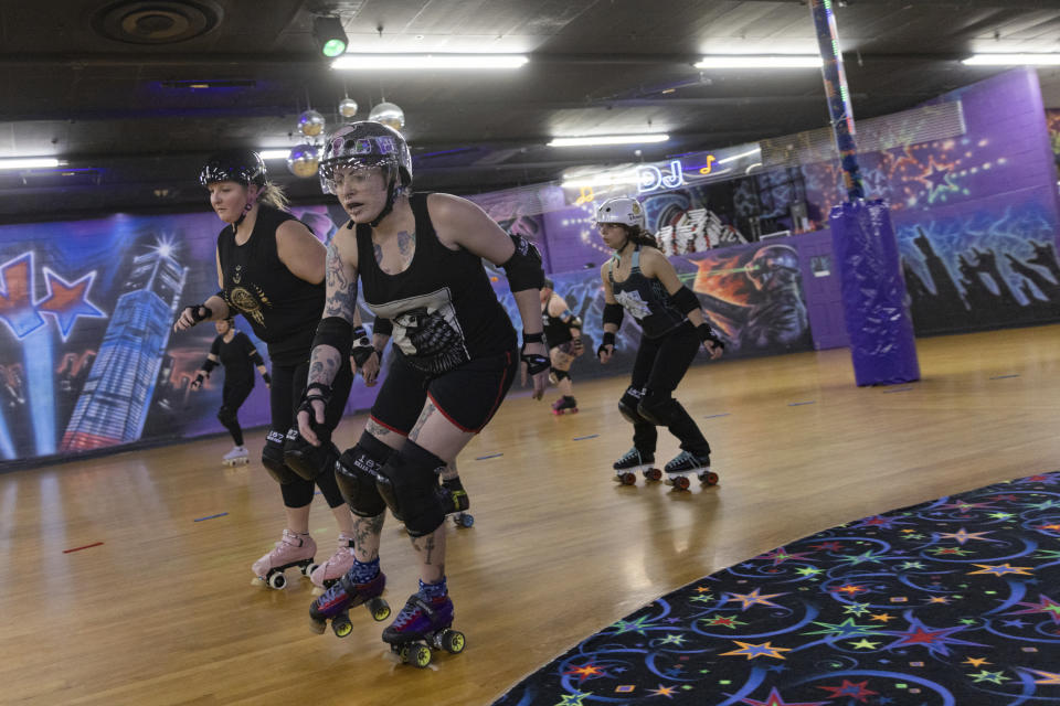 Members of the Long Island Roller Rebels, practice, Tuesday, Mar. 19, 2023, at United Skates of America in Seaford, N.Y. (AP Photo/Jeenah Moon)