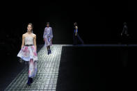 A model wears a creation as part of the Emporio Armani women's Fall-Winter 2024-25 collection presented in Milan, northern Italy, Thursday, Feb. 22, 2024. (AP Photo/Luca Bruno)