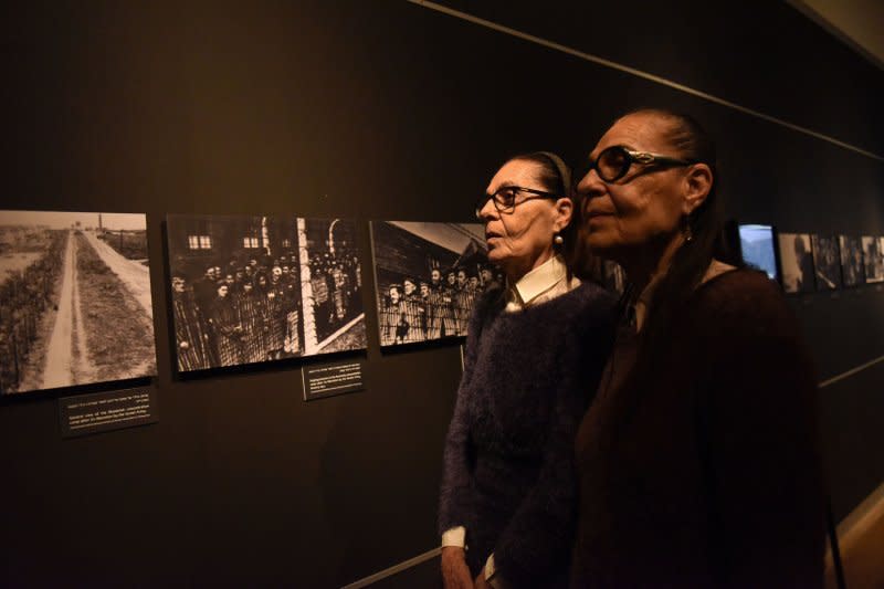 Sisters Lia Huber (L), and Yehudith Barnea (R) 80, surviving "Mengele Twins" of the Holocaust, look at photographs at the Yad Vashem Holocaust Museum in Jerusalem on January 24. They and other Holocaust victims were experimented upon by Josef Mengele, the so-called Angel of Death, who died February 7, 1979. Photo by Debbie Hill/UPI