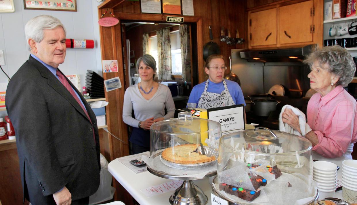 From left, Heather Henriksen, Francesca and Evelyn Marconi watch as Former House Speaker Newt Gingrich eyes the deserts after having lunch at Geno's Chowder and Sandwich shop, Wednesday, March 30, 2011 in Portsmouth, N.H.