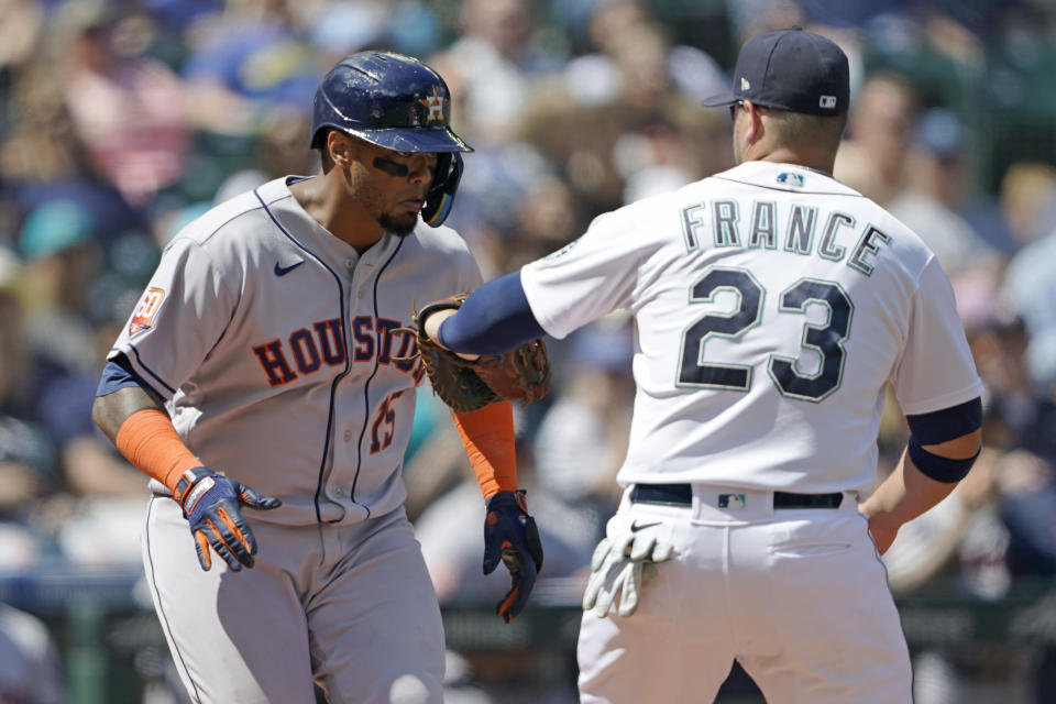 Houston Astros' Martin Maldonado, left, is tagged out by Seattle Mariners first baseman Ty France after a sacrifice bunt during the fifth inning of a baseball game, Saturday, July 23, 2022, in Seattle. (AP Photo/Ted S. Warren)