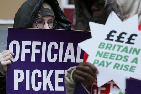 NHS workers hold placards during a strike, outside St Pancras Hospital in London October 13, 2014. REUTERS/Stefan Wermuth