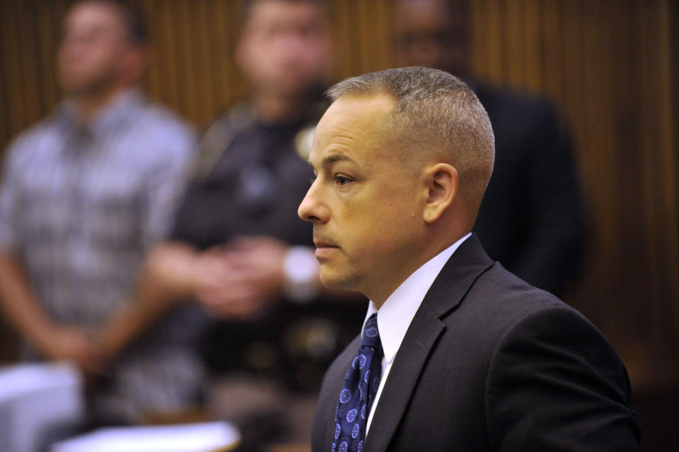 Detroit police officer Joseph Weekley stands in Judge Cynthia Hathaway's courtroom at the Frank Murphy Hall of Justice in Detroit, Michigan on Tuesday, June 18, 2013 as the judge instructs jurors to continue to work toward a verdict after they sent her a note saying they are "stuck". The judge declared a mistrial Tuesday after jurors failed to reach a verdict in the trial. Weekley is charged with involuntary manslaughter in the shooting death of 7-year-old Aiyana Stanley-Jones. (AP Photo/The Detroit News, John T. Greilick) DETROIT FREE PRESS OUT; HUFFINGTON POST OUT