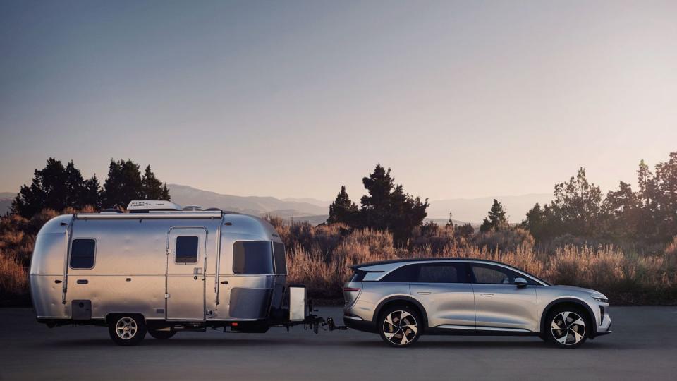 2025 lucid gravity and a trailer parked on a road