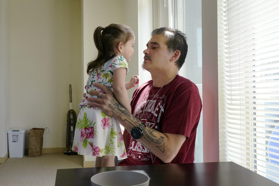 Leroy Pascubillo looks at his daughter, who was born addicted to heroin and placed with a foster family at birth, and talks about his journey regaining custody, May 10, 2021, in Seattle. Pascubillo, who had used drugs for the better part of four decades, was in a court-ordered in-patient drug rehab program when the pandemic first hit. (AP Photo/Elaine Thompson)