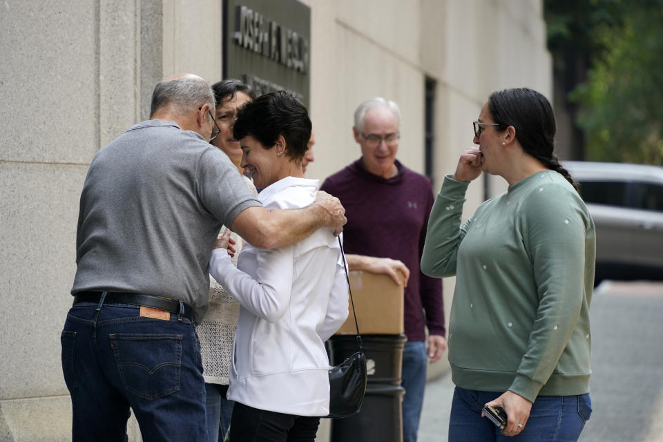 People hug outside the United States Courthouse in Pittsburgh after Robert Bowers was found guilty, Friday, June 16, 2023, in Pittsburgh. Bowers, a truck driver who spewed hatred of Jews, was convicted Friday of barging into a Pittsburgh synagogue on the Jewish Sabbath and fatally shooting 11 congregants in an act of antisemitic terror for which he could be sentenced to die. (AP Photo/Gene J. Puskar)