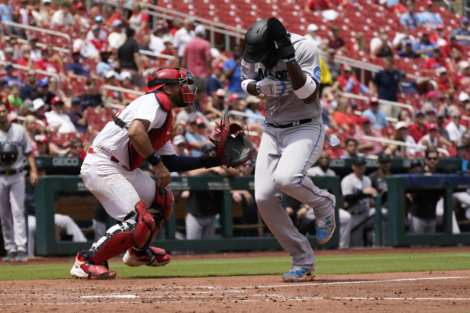 Miami Marlins' Jorge Soler, right, scores past St. Louis Cardinals catcher Ivan Herrera during the third inning of a baseball game Wednesday, July 19, 2023, in St. Louis. (AP Photo/Jeff Roberson)