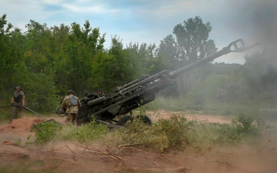 Ukrainian soldiers fire a U.S.-supplied M777 howitzer - Efrem Lukatsky/ AP