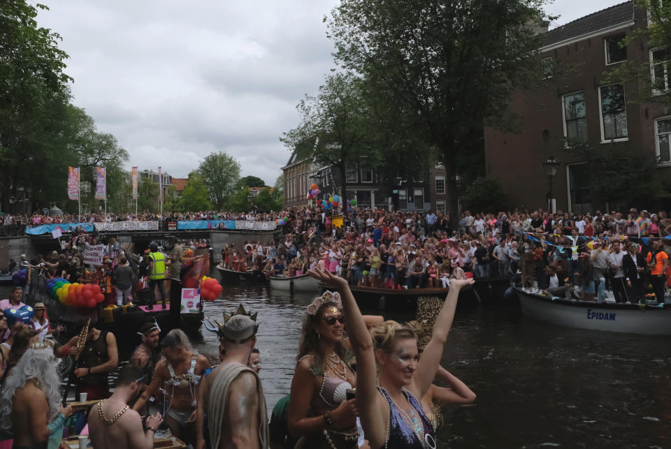 People take part in the Amsterdam Pride Parade, in Amsterdam, Netherlands, Saturday, Aug. 3, 2019. Tens of thousands of spectators are lining one of Amsterdam’s main canals to watch a flotilla of decorated boats make their way through the historic waterway as part of the Dutch capital’s nine-day pride festival. (AP Photo/Michael Corder)