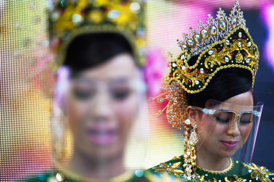 Dancers from Malaysia's pavilion perform wearing face shields due to the coronavirus at Expo 2020, in Dubai, United Arab Emirates, Sunday, Oct. 3, 2021. (AP Photo/Jon Gambrell)