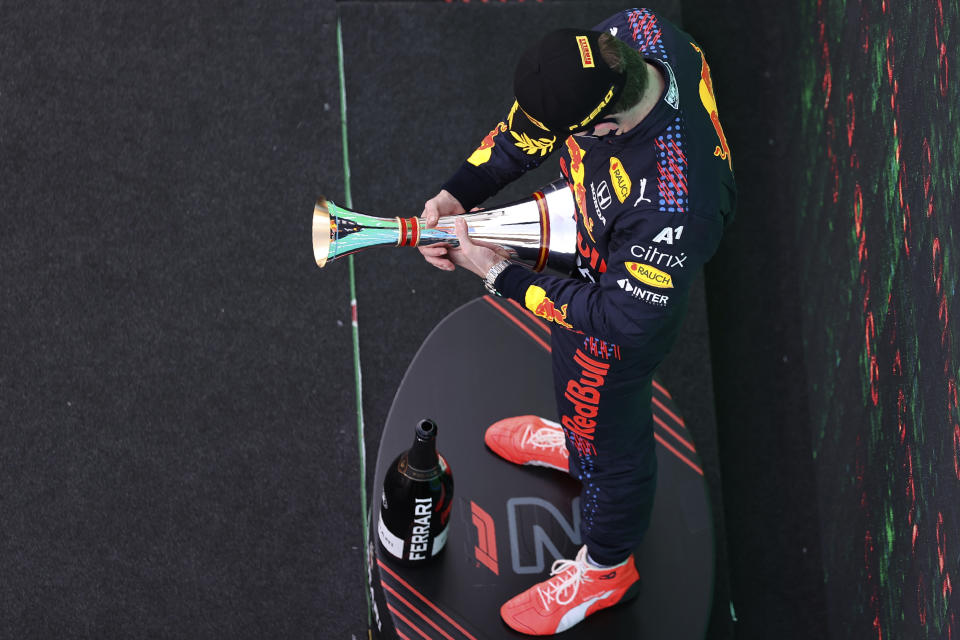 Red Bull driver Max Verstappen of the Netherlands looks at his second place trophy on the podium of the Spanish Formula One Grand Prix at the Barcelona Catalunya racetrack in Montmelo, just outside Barcelona, Spain, Sunday, May 9, 2021. (Lars Baron/Pool via AP)