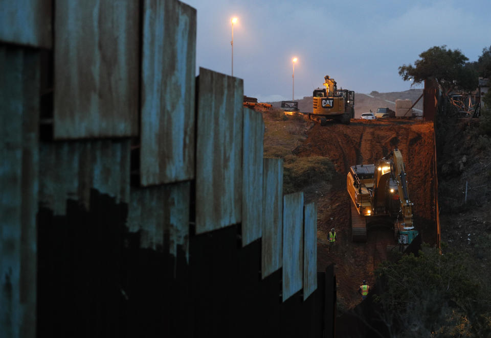 Contractors work to reinforce a section of the U.S. border wall between San Diego and Tijuana, where scores of Central American migrants have crossed illegally in recent weeks. (Photo: Rebecca Blackwell/AP)