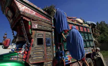 Afghan women board a truck returning to Afghanistan in Peshawar in this October 21, 2014 file photo. REUTERS/Fayaz Aziz/Files