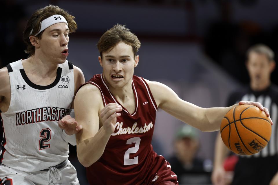 Charleston's Reyne Smith, right, drives past Northeastern's Glen McClintock during the first half of an NCAA college basketball game, Saturday, Jan. 21, 2023, in Boston. (AP Photo/Michael Dwyer)