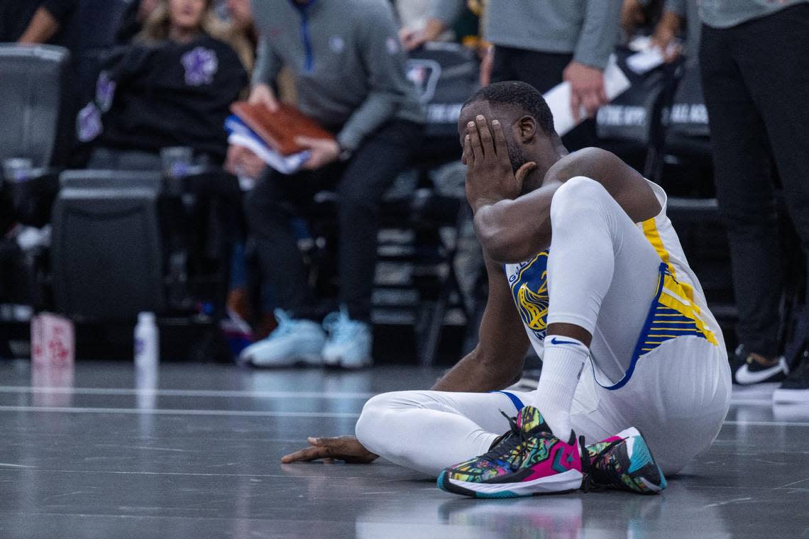 Golden State Warriors forward Draymond Green (23) holds his cheek during an NBA in-season tournament game at Golden 1 Center on Tuesday, Nov. 28, 2023.