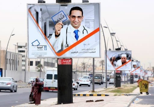 A poster in Tripoli shows a medic holding an election card promoting voting in the National Congress elections. Elections in Libya for a constituent assembly, originally set to be held by June 19, are to be postponed for logistical reasons, electoral commission members said on Saturday
