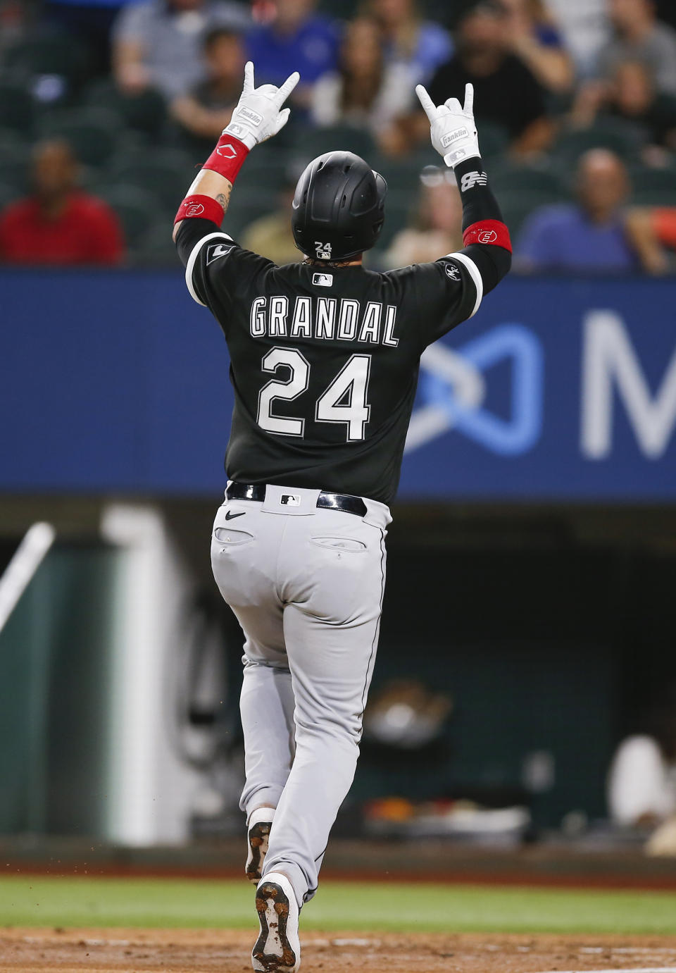 Chicago White Sox's Yasmani Grandal celebrates after hitting a solo home run during the sixth inning of a baseball game against the Texas Rangers, Saturday, Sept. 18, 2021, in Arlington, Texas. (AP Photo/Brandon Wade)