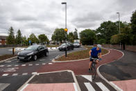 A cyclist uses the UK's first Dutch-style roundabout � which prioritises cyclists and pedestrians over motorists � after it opened in Fendon Road, Cambridge. The cost of the scheme, originally estimated at around GBP 800,000, has almost trebled to GBP 2.3m at the end of the project.