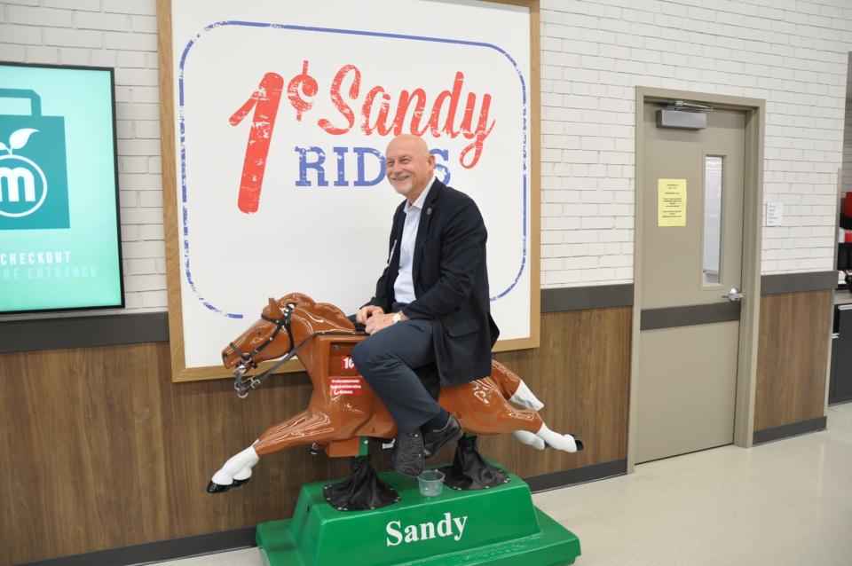 North Canton Mayor Stephan Wilder rides Meijer's iconic penny pony ride, Sandy, on May 8, 2024, during a tour of the new North Canton store. It opens to the public on May 14.