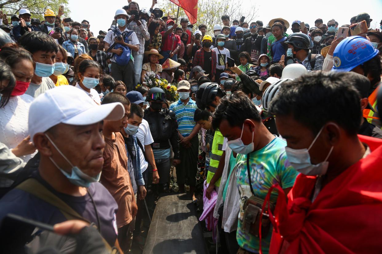 <p>People gather around the coffin of Ma Kyal Sin during her funeral in Mandalay, Myanmar on 4 March. The teenager, who was wearing the T-shirt ‘Everything will be ok’ was killed during the violence on Wednesday</p> (EPA)