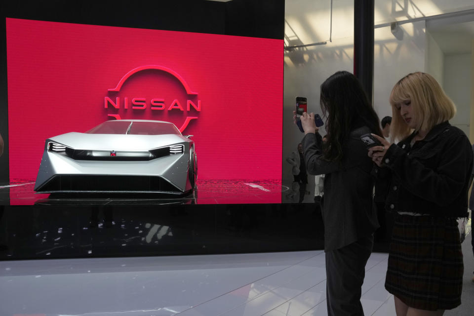 Visitors stand near a concept car from Nissan during Auto China 2024 held in Beijing, Thursday, April 25, 2024. Global automakers and EV startups unveiled new models and concept cars at China's largest auto show on Thursday, with a focus on the nation's transformation into a major market and production base for digitally connected, new-energy vehicles. (AP Photo/Ng Han Guan)