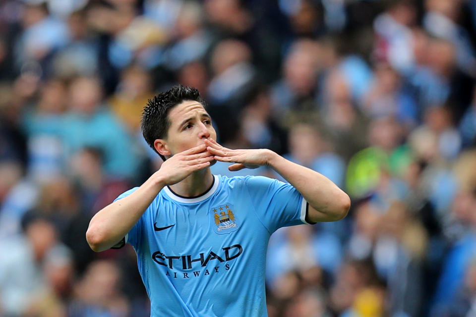 Manchester City's Samir Nasri blows a kiss as he celebrates his goal during the English Premier League soccer match between Manchester City and West Ham at the Etihad Stadium in Manchester, England, Sunday May 11, 2014. (AP Photo/Jon Super)