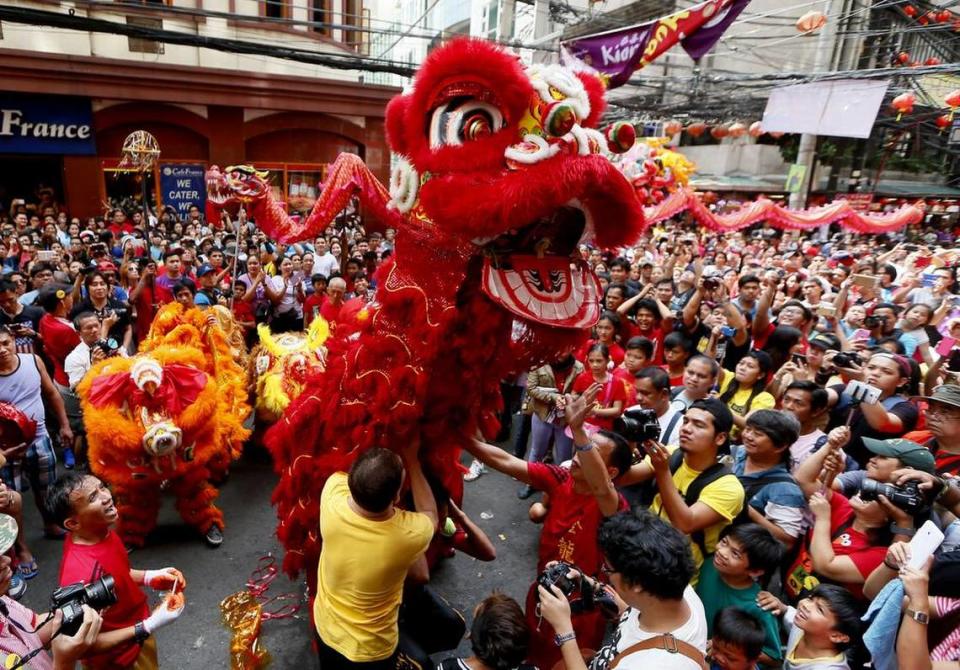 Dragon and lion dancers perform before a huge crowd in celebration of the Chinese Lunar New Year Monday, Feb. 8, 2016 at Manila’s Chinatown district in Manila, Philippines.