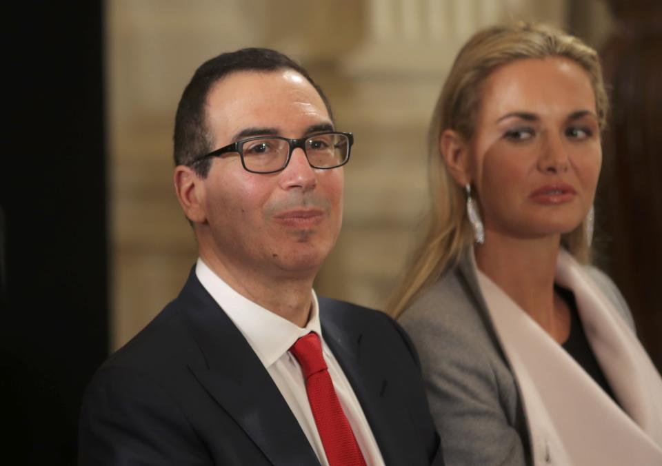 Treasury Secretary nominee Steven Mnuchin sits with Vanessa Trump (R), wife of Donald Trump Jr, before a swearing-in ceremony for senior staff at the White House in Washington, DC January 22, 2017. REUTERS/Carlos Barria