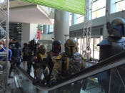 Jango Fett, Boba Fett, Freddy Fett… and all their pals, armored up in their finest regalia, take the escalator. Guess the Slave I was in the shop?