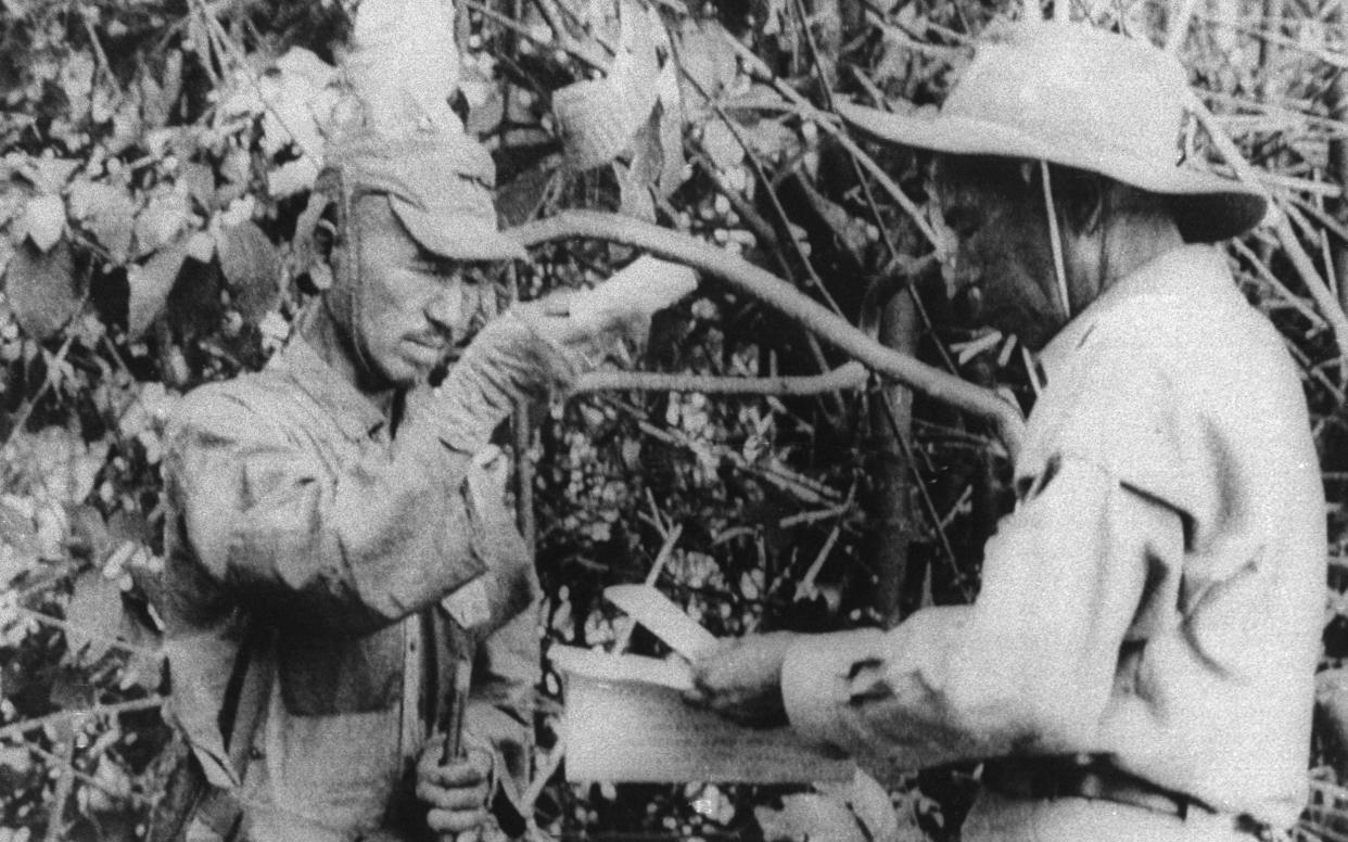 Imperial Japanese Army intelligence officer Hiroo Onoda (left) didn't realise that Japan had surrendered in 1945, and kept fighting on the island of Lubang until 1974, when his former commanding officer (right) was brought out of retirement to order him to stand down - Alamy