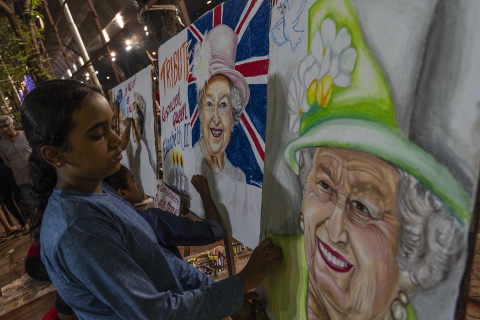 <p>A student of Gurukul art school create a painting as tribute to Queen Elizabeth II, in Mumbai, India, Friday, Sept. 9, 2022. Queen Elizabeth II, Britain's longest-reigning monarch and a rock of stability across much of a turbulent century, died Thursday after 70 years on the throne. She was 96. (AP Photo/Rafiq Maqbool)</p> 