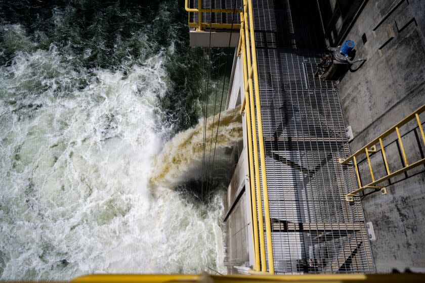 WINCHESTER, CA - MARCH 27, 2023: Water cascades into Damond Valley Lake from the DVL's inlet/outlet tower on March 27, 2023 in Winchester, California. The Metropolitan Water District of Southern California is refilling the region's largest reservoir with state's supplies made available by this winter's storms. It's the first time in three years the reservoir has been refilled. It will take the rest of the year to fill.(Gina Ferazzi / Los Angeles Times)