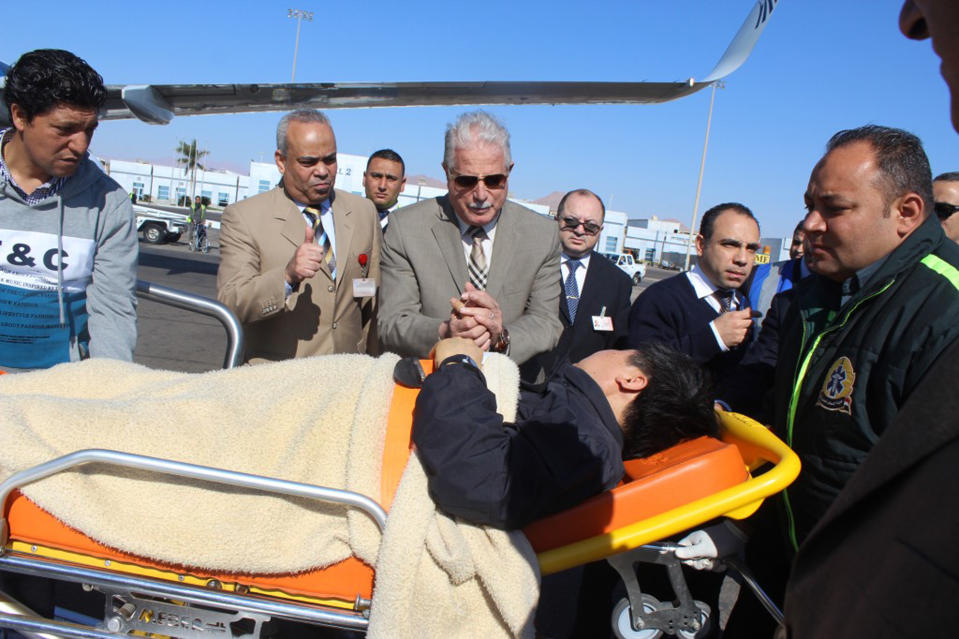 In this photo released by the Office of the South Sinai Governor, Governor of South Sinai, Major General Khaled Foda, center, and other officials sees off a South Korean tourist who was wounded in a deadly blast Sunday, on a bus in Taba, being evacuated home, at Sharm el Sheikh airport, Egypt, Wednesday, Feb. 19, 2014. The bombing Sunday was the first targeting foreign tourists in the Sinai in nearly decade, raising fears that Islamic militants who have been waging a campaign of violence against security forces in the peninsula are now turning to attack tourism, a pillar of Egypt's economy. (AP Photo/Office of the South Sinai Governor)