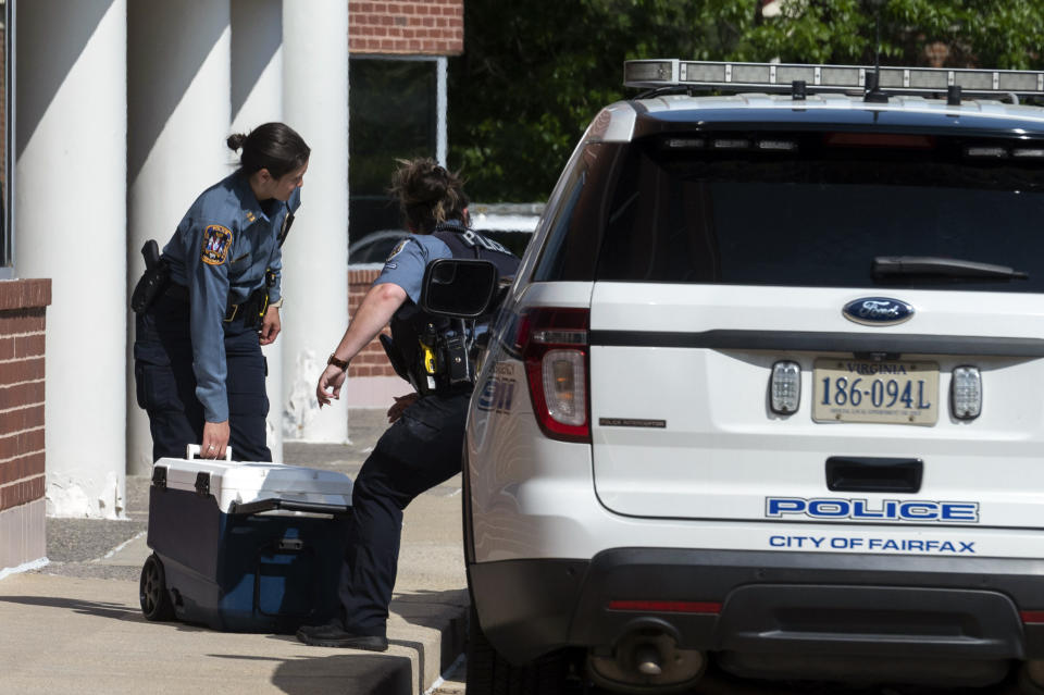 Officers work outside the Fairfax, Va., office building where police say a man wielding a baseball bat attacked two staffers for U.S. Rep. Gerry Connolly, D-Va., on Monday, May 15, 2023. Fairfax City Police in northern Virginia said in a tweet that a suspect is in custody and the victims are being treated for injuries that are not life-threatening. (AP Photo/Cliff Owen)