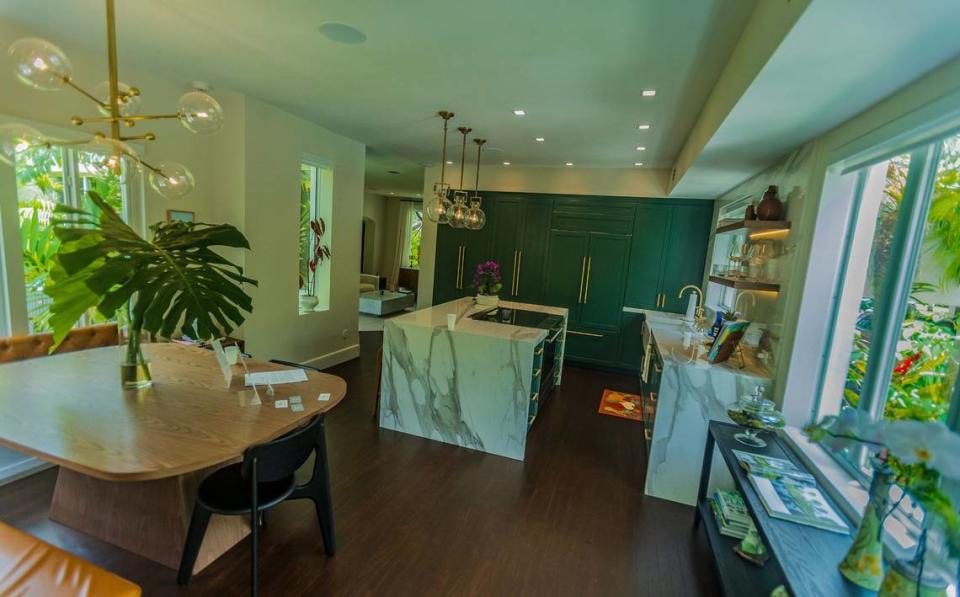 View of the kitchen at a house built in 1925 by architect Marion Manley, who was the first registered woman architect in South Florida. Owners Russ Colombo and Alain Carrazana renovated their kitchen during the pandemic. Formerly a dining room with tile flooring, the couple used original wood flooring from their master suite to give a seamless look from the living room into the kitchen.