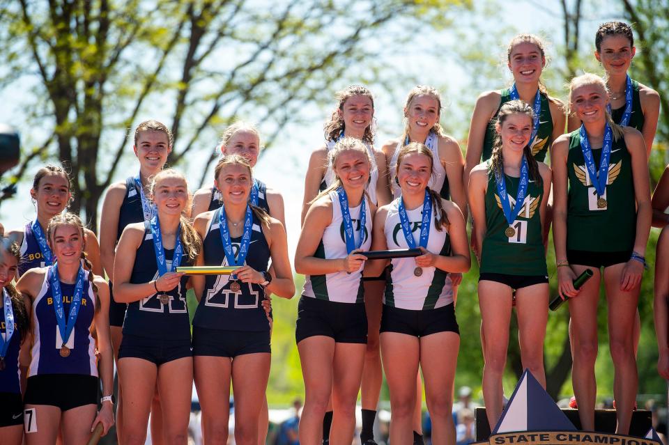 5A girls relay smile on the podium while accepting their girls 4x800-relay medals during the Colorado track & field state championships on Thursday, May 16, 2024 at Jeffco Stadium in Lakewood, Colo. Fossil Ridge (middle, white tops) was runner-up in the event.