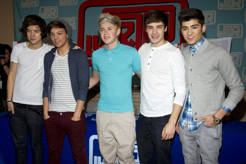 FILE- In this March 12, 2012 file photo, One Direction band members  from left, Harry Styles, Louis Tomlinson, Niall Horan, Liam Payne and Zayn Malik pose during a CD signing for their debut album "Up All Night," at J&R Music World in New York. Malik said Wednesday, March 25, 2015, he is leaving chart-topping boy band One Direction "to be a normal 22-year-old." His bandmates said they were sad to see him go "but we totally respect his decision and send him all our love for the future." (AP Photo/Charles Sykes, File)