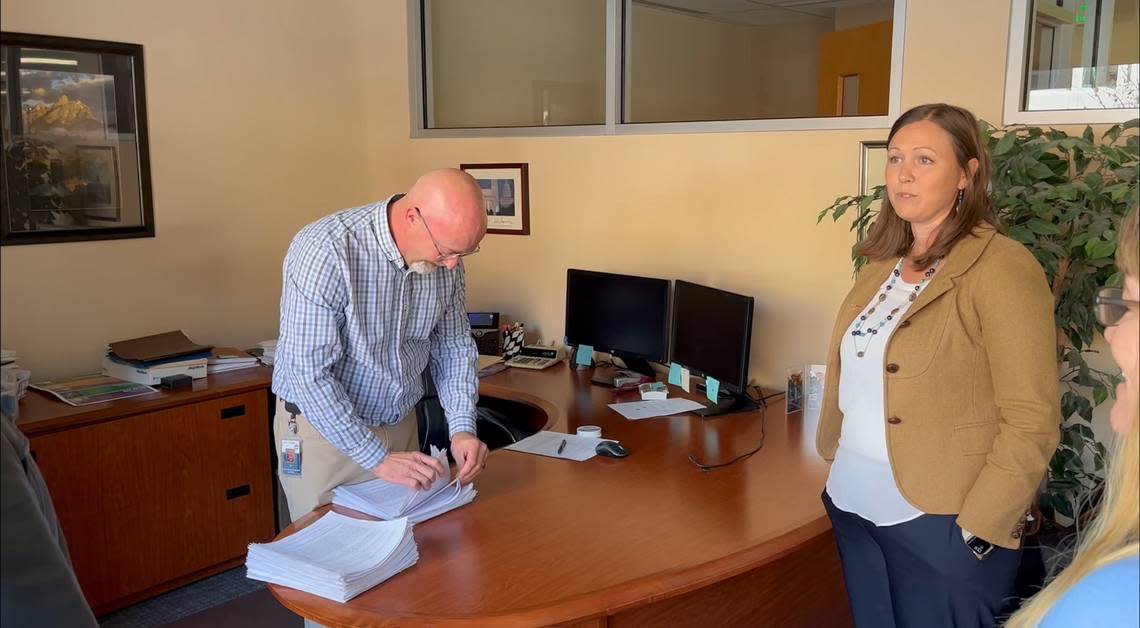 Ed Kopp, Boise’s supervisor of licenses and permits, counts signed petitions submitted by the Boise Parks Association. One of the group’s directors, Aimee Russell, looks on.