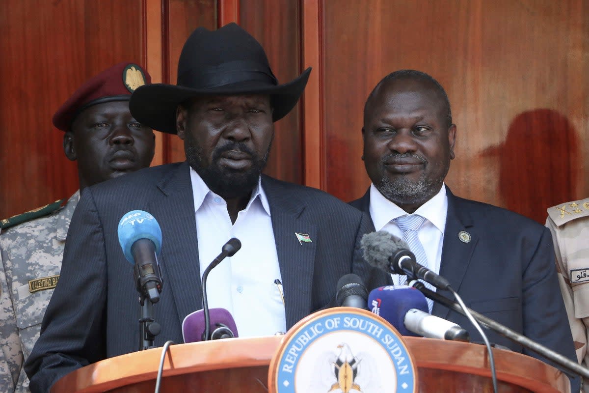 South Sudan President Salva Kiir (C) gives a press conference jointly with his former vice-president and political rival Riek Machar (R) after they met at the State House in Juba, where they confirmed that they had agreed to a joint government in February 2020 (AFP via Getty Images)