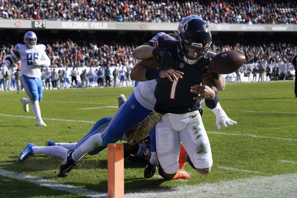 Detroit Lions linebacker Alex Anzalone (34) tackles Chicago Bears quarterback Justin Fields (1) during the first half of an NFL football game in Chicago, Sunday, Nov. 13, 2022. (AP Photo/Nam Y. Huh)