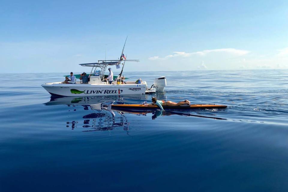 With a support boat guiding her, Holly Heidenreich, a firefighter and EMT with the Destin Fire Control District, paddles her board during last month's 2022 Crossing For Cystic Fibrosis challenge. Heidenreich and her teammate Megan Scully from Lake Worth, paddled 80 miles from Bimini, Bahamas to the mainland of Florida in the event, which raises funds for and brings attention to those living with cystic fibrosis.