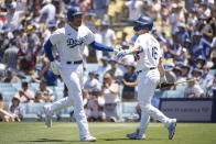 Los Angeles Dodgers' Freddie Freeman, left, celebrates after his solo home run with Will Smith during the third inning of a baseball game against the Cleveland Guardians in Los Angeles, Sunday, June 19, 2022. (AP Photo/Kyusung Gong)