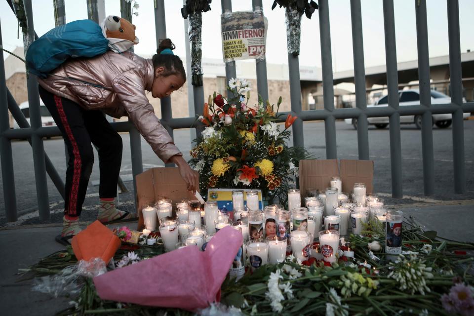 A girl lights candle during a vigil for the victims of a fire at an immigration detention center that killed dozens in Ciudad Juarez, Mexico. According to Mexican President Andres Manuel Lopez Obrador, migrants fearing deportation set mattresses ablaze at the center, starting the fire. (AP Photo/Christian Chavez) ORG XMIT: XMC156