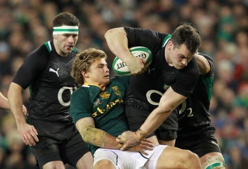 Ireland's prop Cian Healy (R) is tackled by South Africa's fly half Pat Lambie (2nd L) during their Autumn International rugby union match at the Aviva stadium in Dublin, Ireland. South Africa overturned a first half deficit and ill-discipline to open their November tour of the northern hemisphere with a deserved 16-12 victory