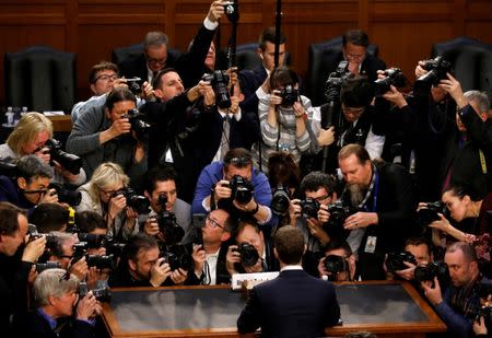 FILE PHOTO: Facebook CEO Mark Zuckerberg is surrounded by members of the media as he arrives to testify before a Senate Judiciary and Commerce Committees joint hearing regarding the company's use and protection of user data, on Capitol Hill in Washington, U.S., April 10, 2018. To match Special Report MYANMAR-FACEBOOK/HATE REUTERS/Leah Millis/File Photo