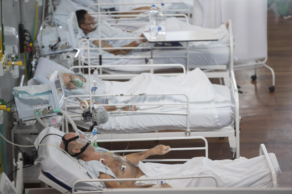 COVID-19 patients lie at a field hospital set inside a sports coliseum in Santo Andre, on the outskirts of Sao Paulo, Brazil, Thursday, March 4, 2021. (AP Photo/Andre Penner)