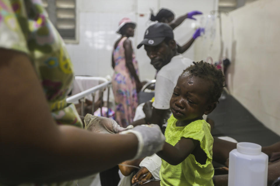 A child injured by the recent 7.2 magnitude earthquake is treated at the Immaculee Conception hospital in Les Cayes, Haiti, Thursday, Aug. 19, 2021. (AP Photo/Joseph Odelyn)