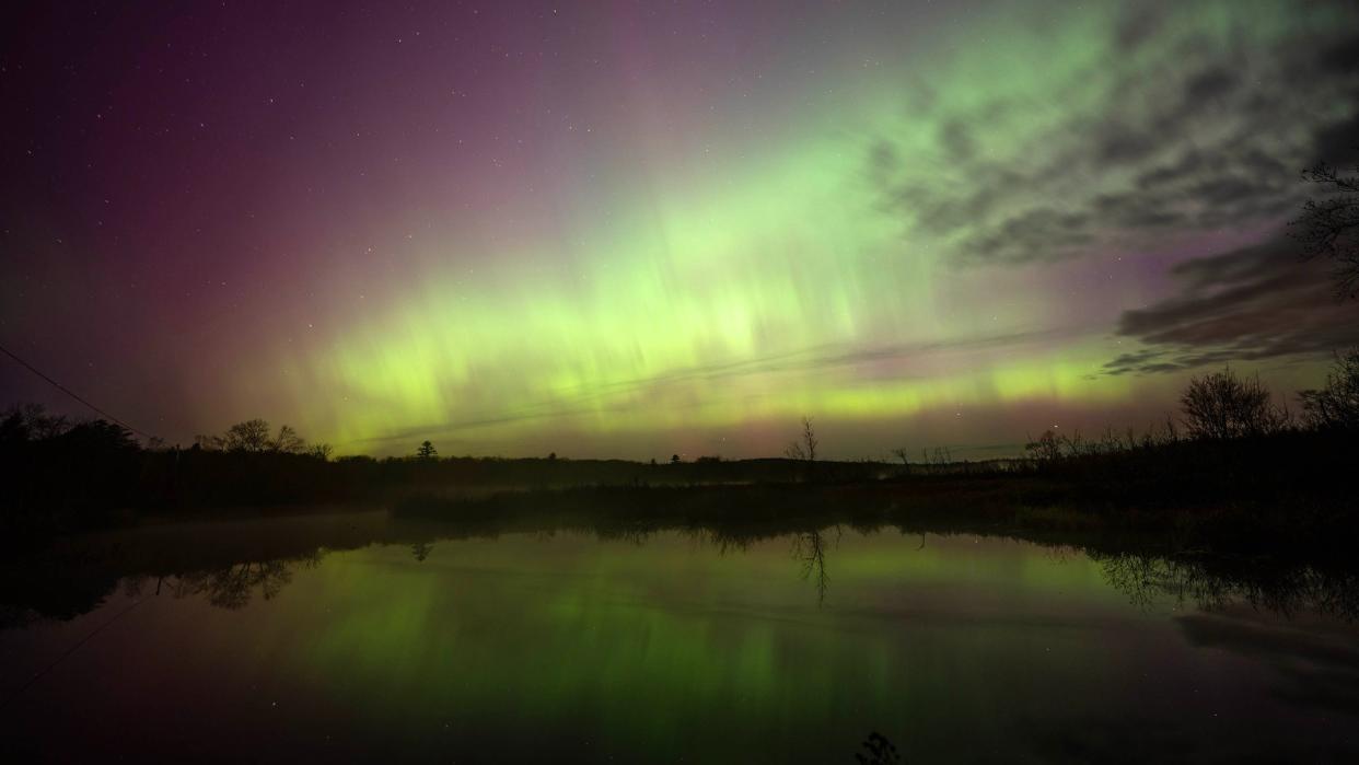  Colorful wisps of light appear in the night sky. 