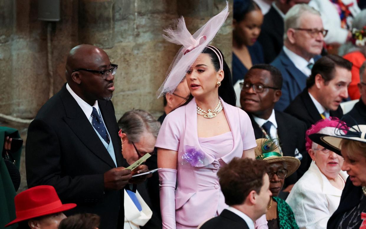 Katy Perry, accompanied by Edward Enninful, editor-in-chief of British Vogue, looks around Westminster Abbey for her seat - Getty Images Europe