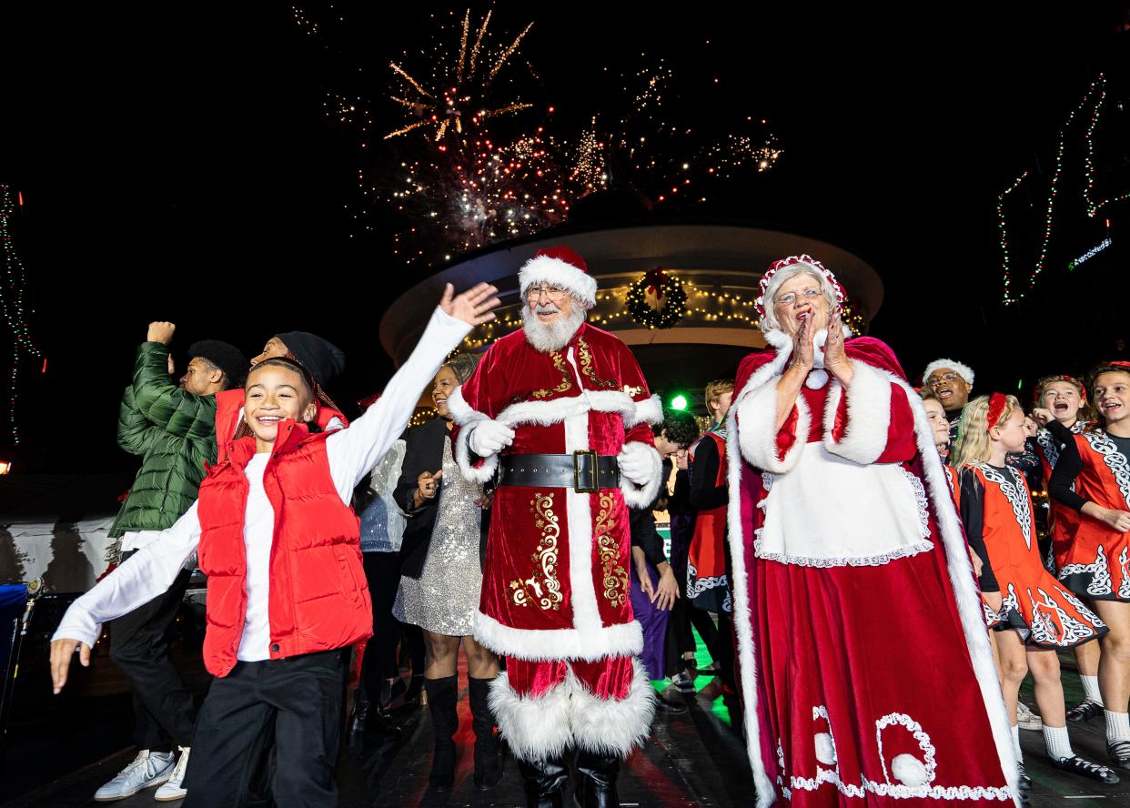 Santa waves to the crowd as fireworks start during the 25th annual Milwaukee Holiday Lights Festival on Nov. 16 at Pere Marquette Park in Milwaukee. There are lots of opportunities to visit with Santa before he makes his rounds on Christmas Eve.